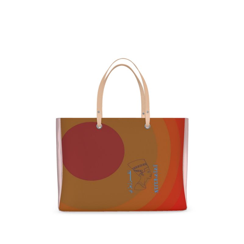 A handbag with pink handles and in the front is the image of Nefertiti's head  and my logo is in an Arabic and English writing.