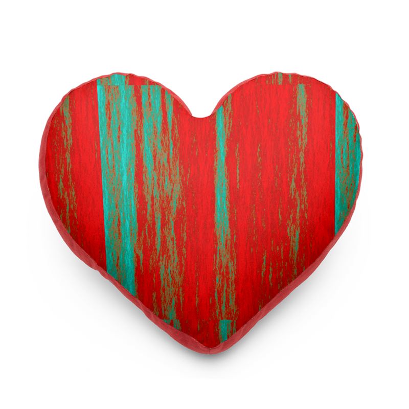 A heart shaped cushion in green and red  and the back is in pink. 